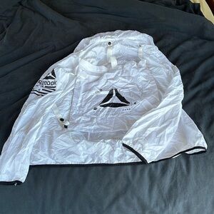 Workout jacket with attached pack on the back